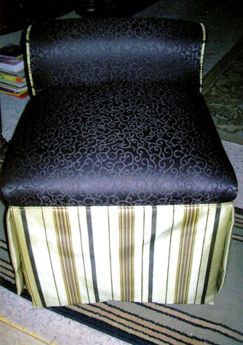 Short backed Parson's chair with seat upholstered in scroll fabric and skirt in striped fabric